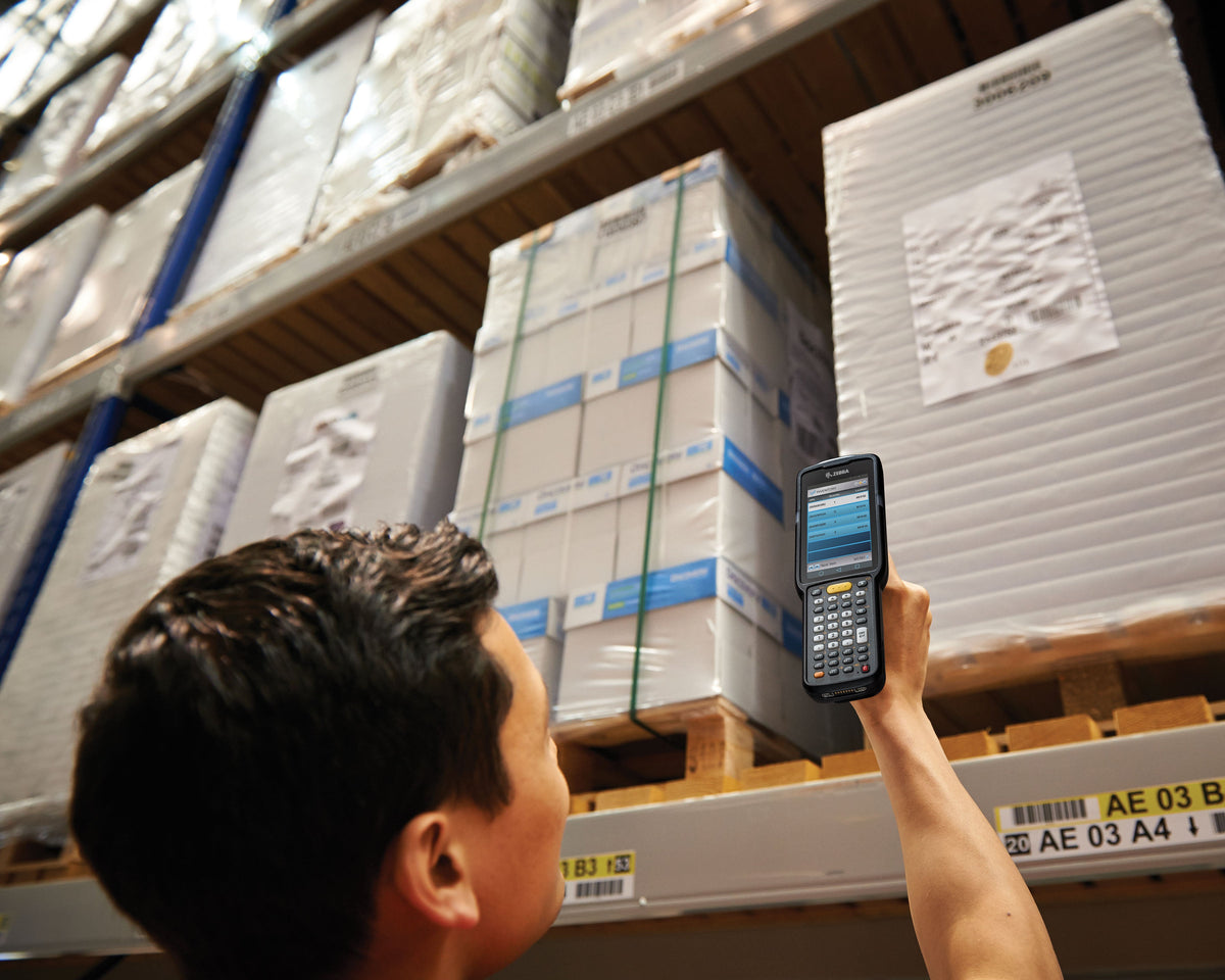 Zebra MC3300x rugged keypad mobile computer, pistol grip, 38-key function numeric keypad (MC330L-GJ3EG4RW) – in use in a warehouse