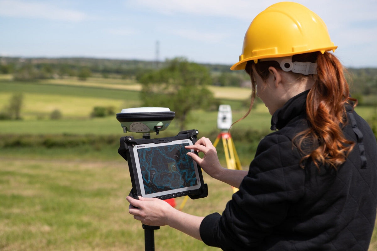 Surveyor using the Panasonic TOUGHBOOK G2 mk3 (Wi-Fi, micro-SD reader, fingerprint reader, UK plug) on a GNSS pole for field mapping and GIS data capture