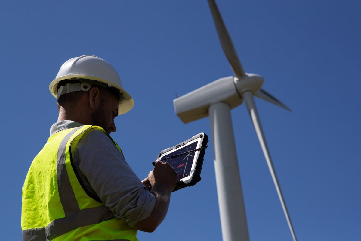 Wind farm engineer using the Panasonic TOUGHBOOK G2 mk3 (Wi-Fi, micro-SD reader, fingerprint reader, UK plug) rugged tablet outdoors in direct sunlight